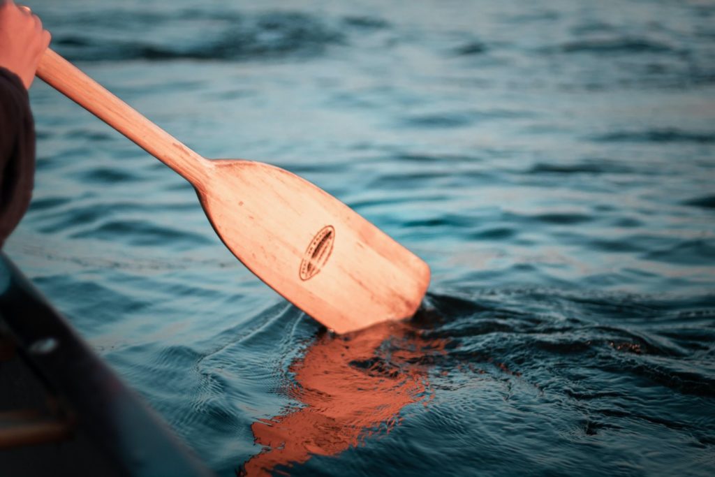 paddling a canoe on a lake