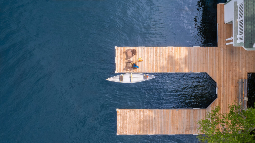 Muskoka cottage dock with canoe and people discussing tax planning