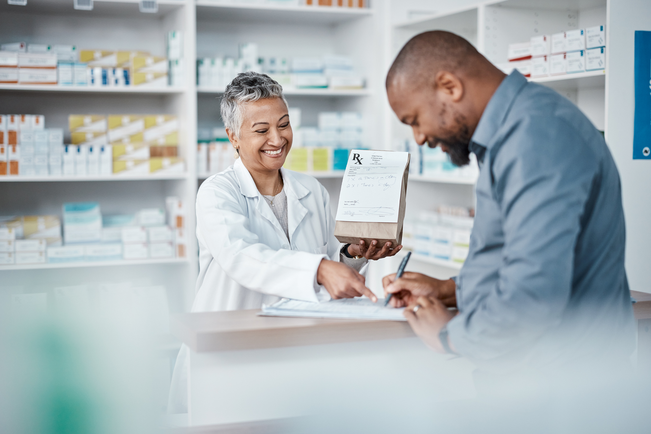 Pharmacy clients discussing National Pharmacare program